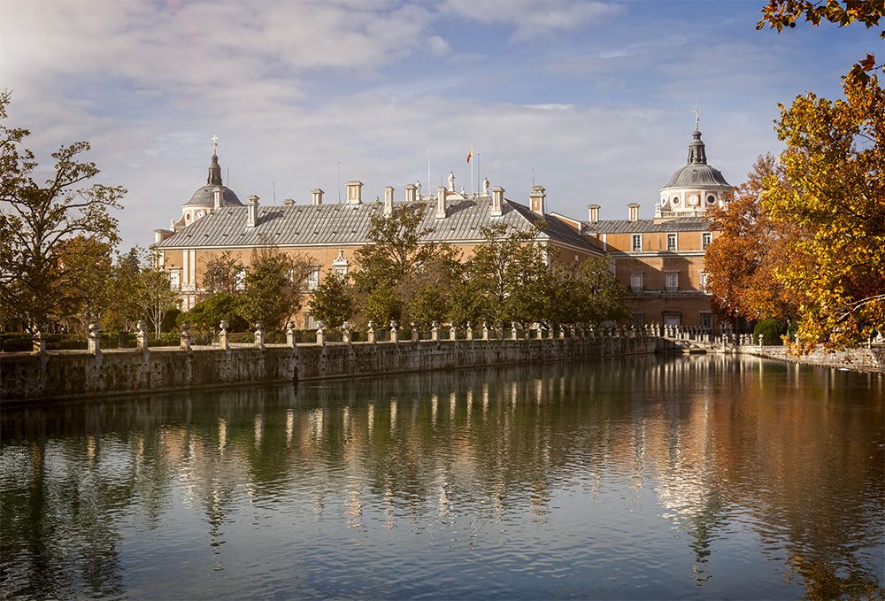 The Royal Palace of Aranjuez seen across an ornamental pond in the palace gardens.
