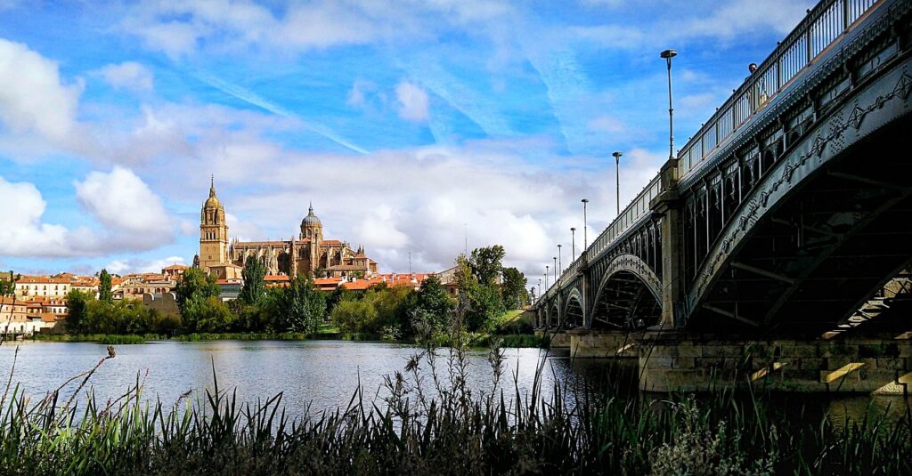 Salamanca boasts two cathedrals: The Old & New Cathedral of Salamanca seen from the river.